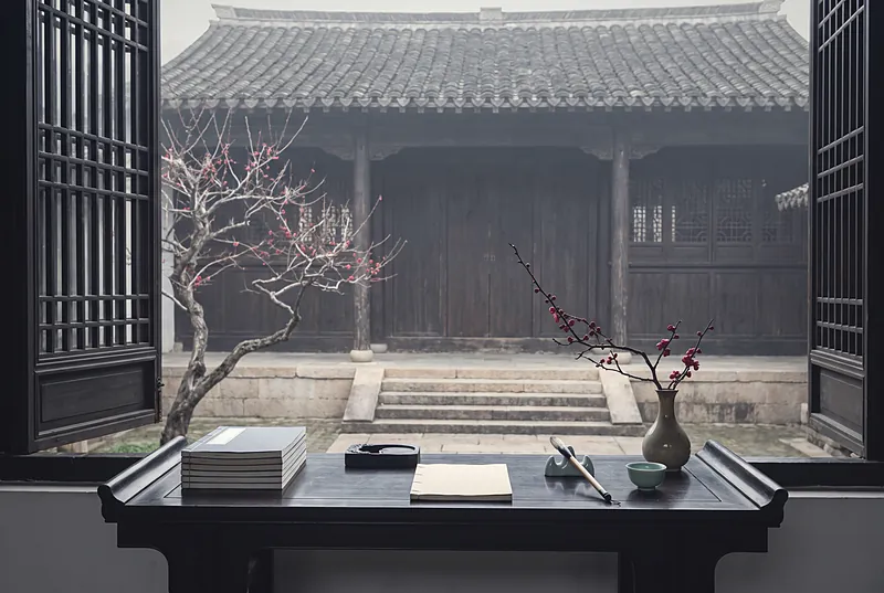 冬日古书院庭院中的书案,摆着书卷和笔墨,一枝梅花静静开放